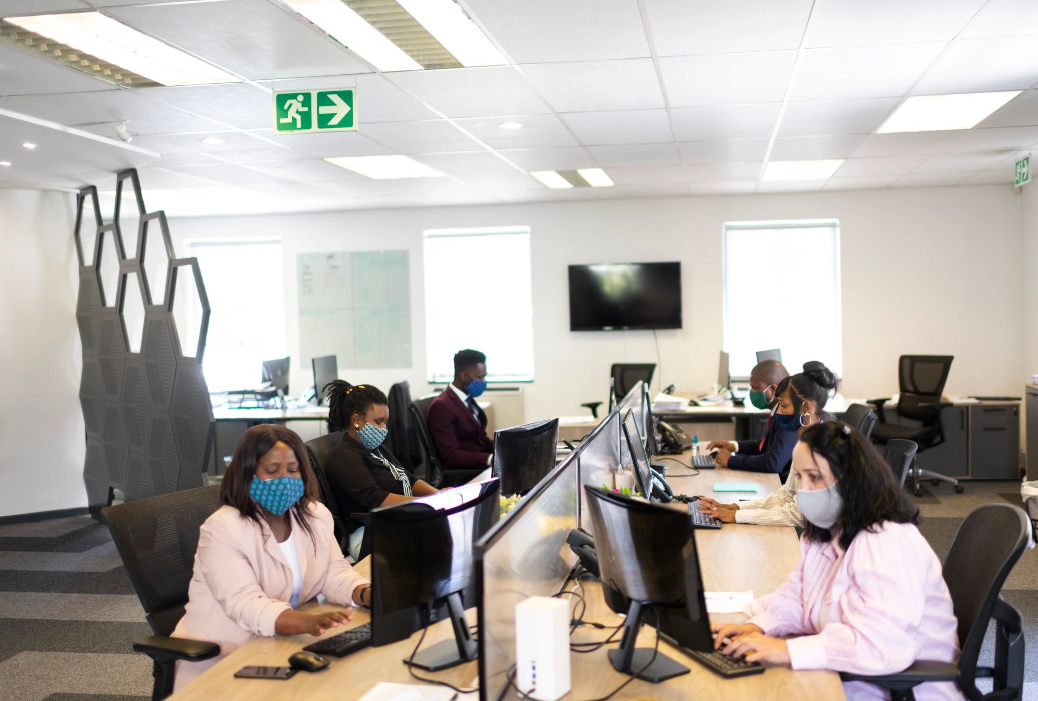 Wide shot corporate office workers wearing protective mask during covid-19 pandemic