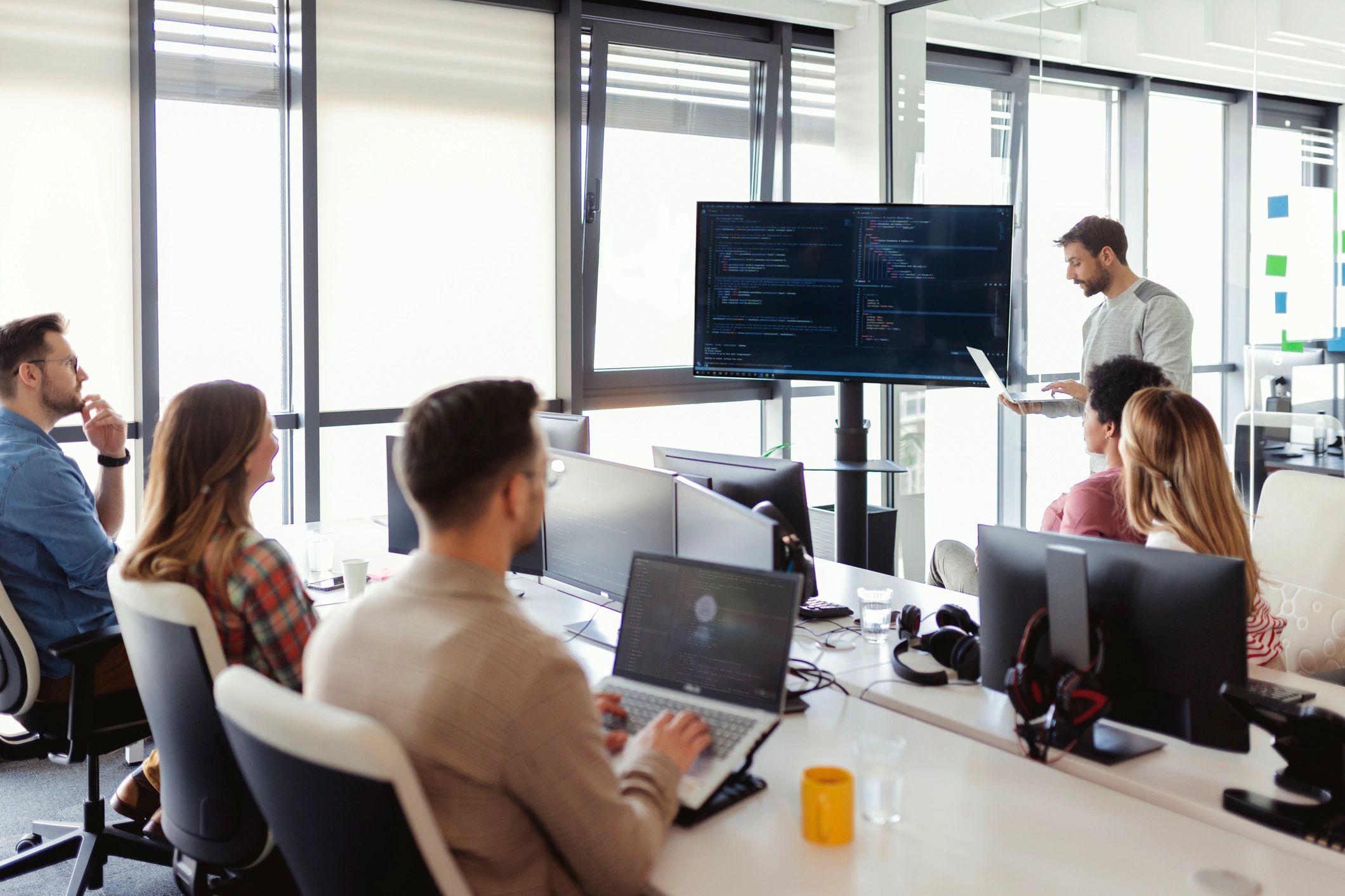 Technicians collaborating around a monitor to provide IT support