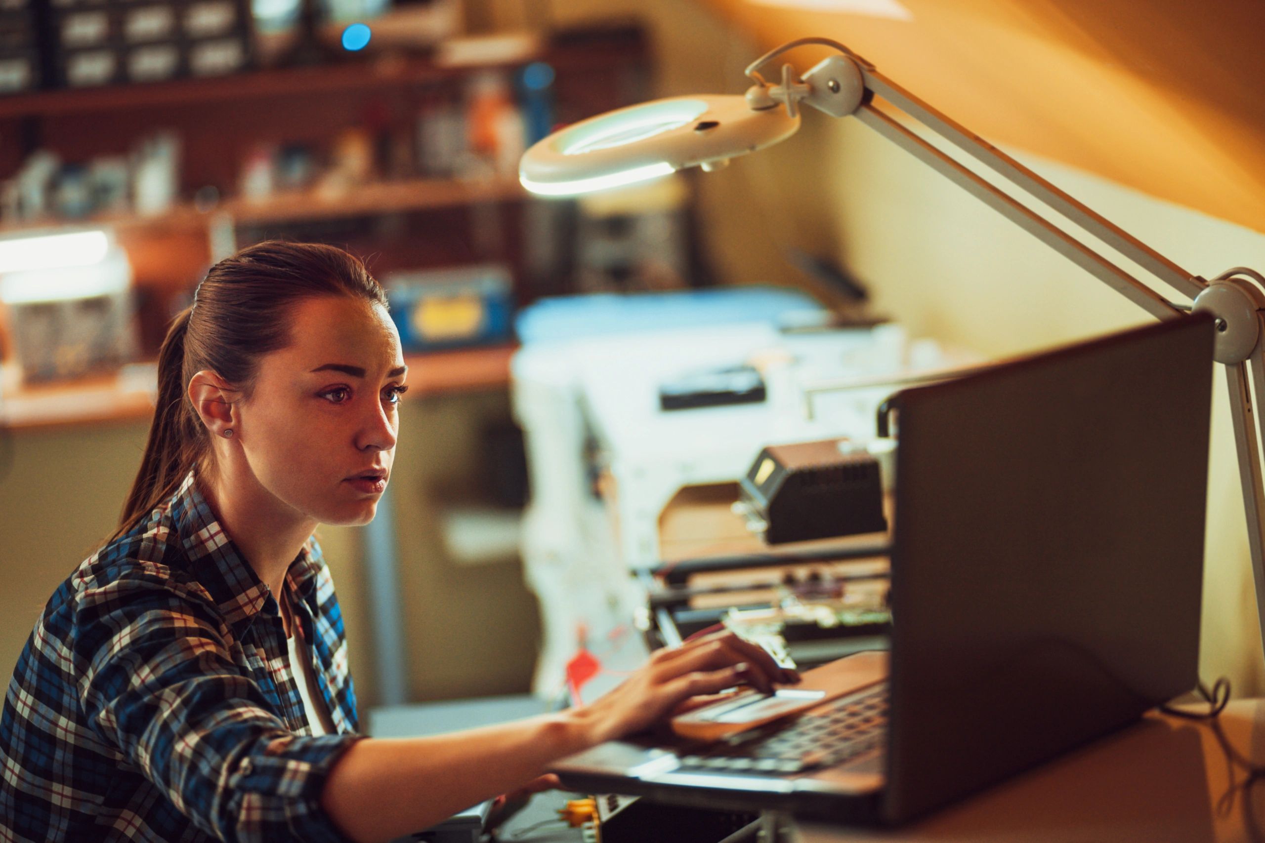 Technician inspecting a computer at a service desk