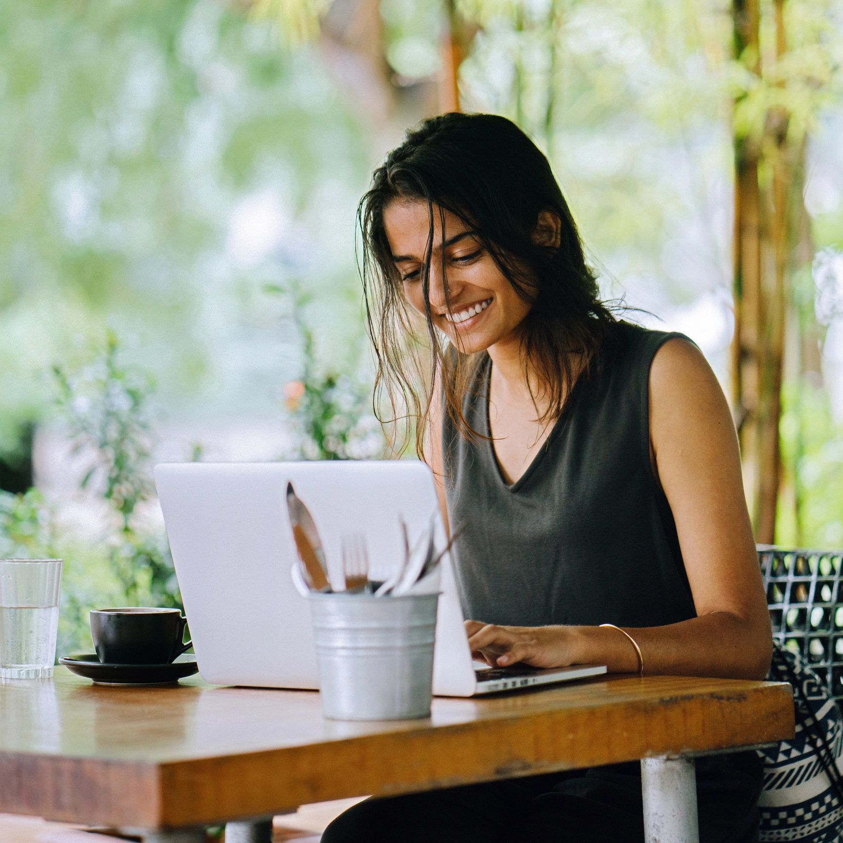 Portrait of a smiling customer using a laptop
