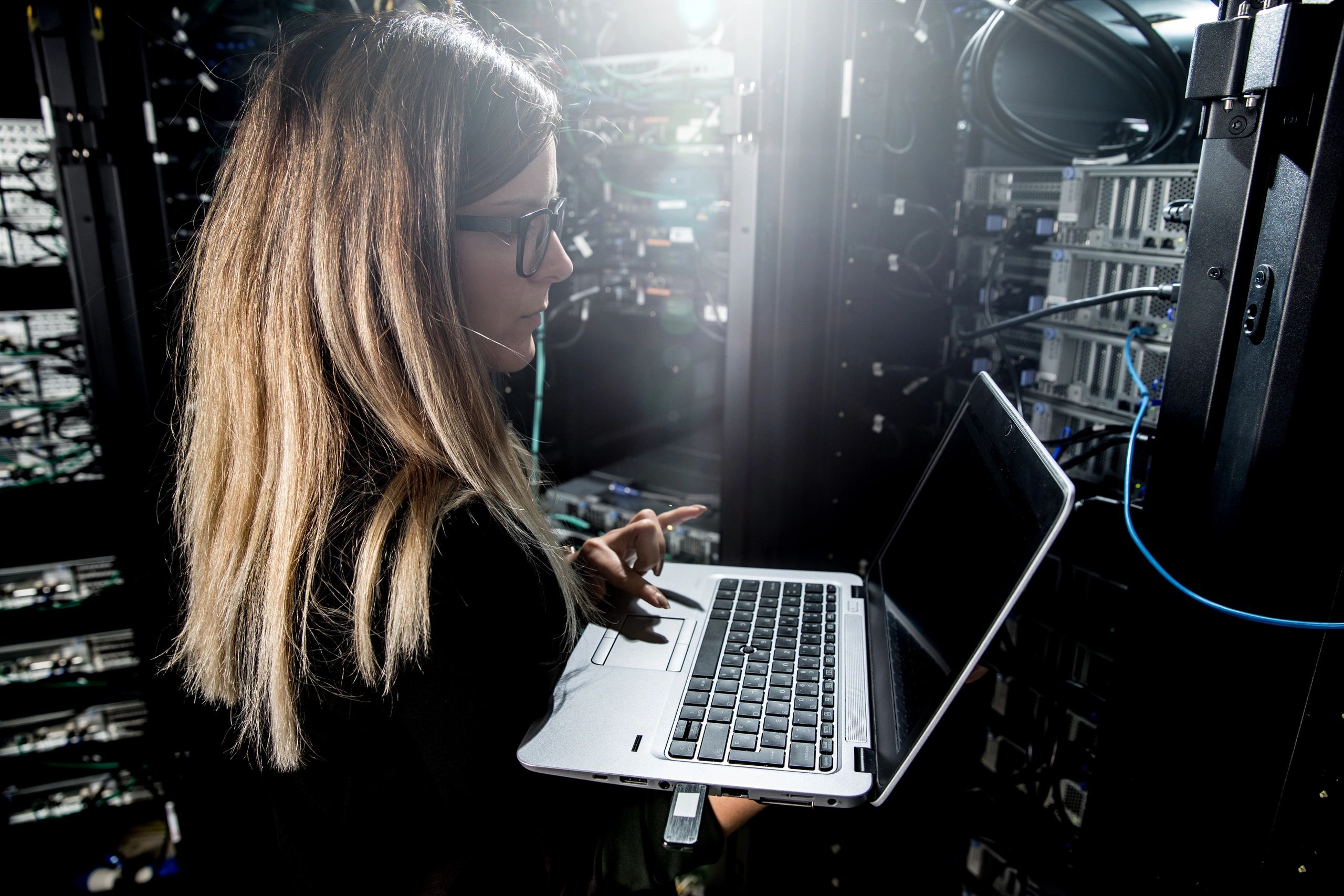 Engineer with server rack and servers